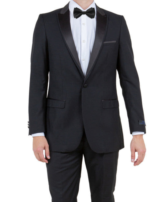 Man wearing a black tuxedo with a bow tie on a white background