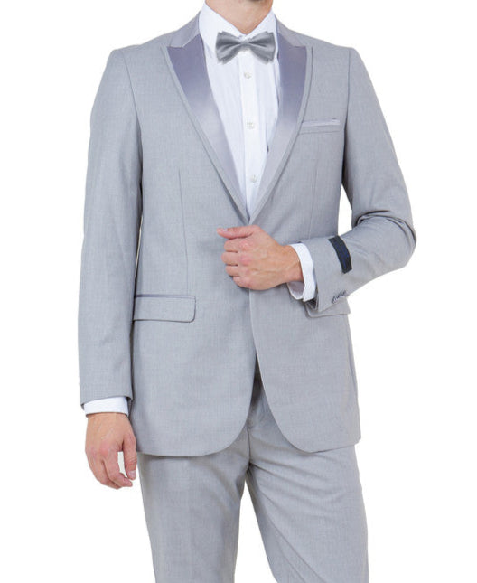 Man wearing a gray suit with a white shirt and black shoes on a white background