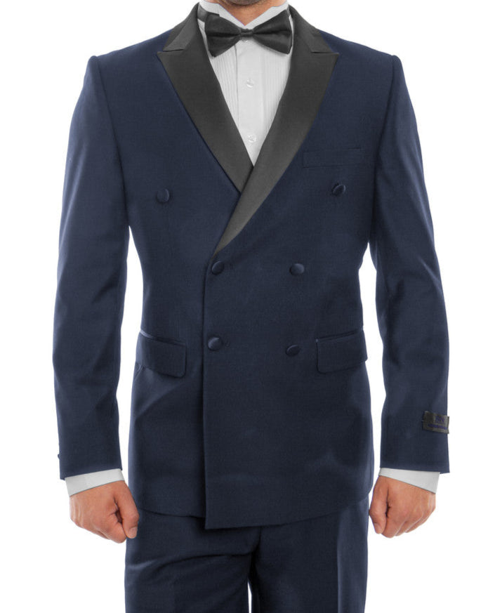 Man wearing a navy blue tuxedo with black lapels on a white background