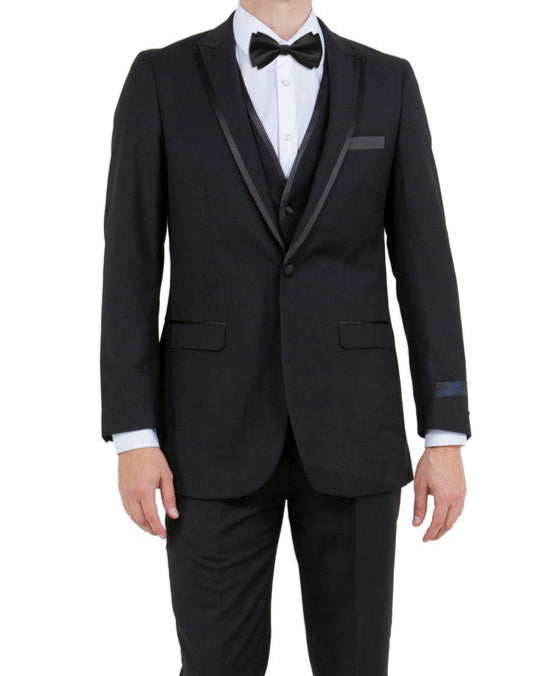 Man wearing a black tuxedo with a bow tie on a white background