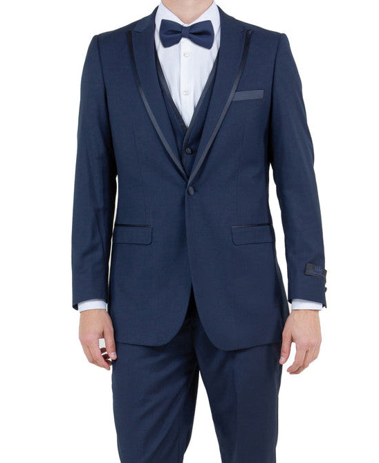 Man wearing a navy blue suit with a white shirt and black shoes on a white background