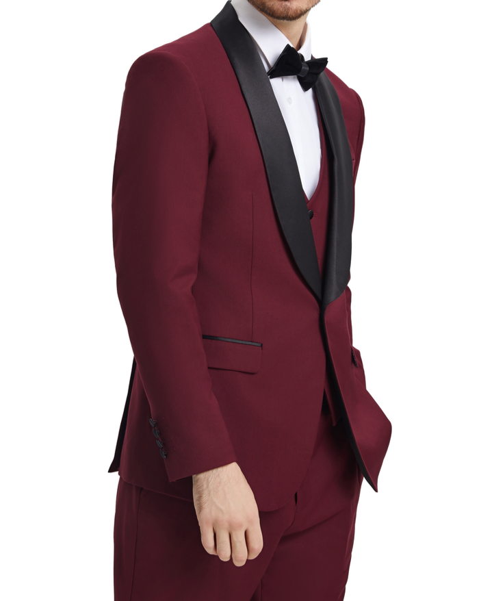 Man wearing a burgundy tuxedo with black lapels on a white background